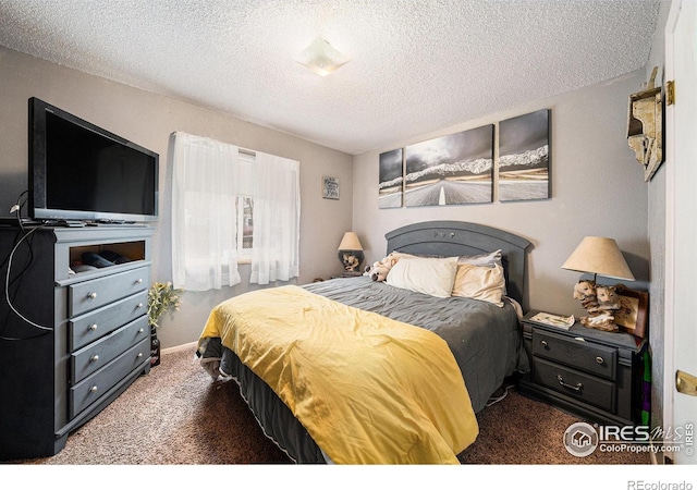bedroom with carpet floors and a textured ceiling