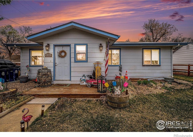view of front of home featuring a front yard and fence