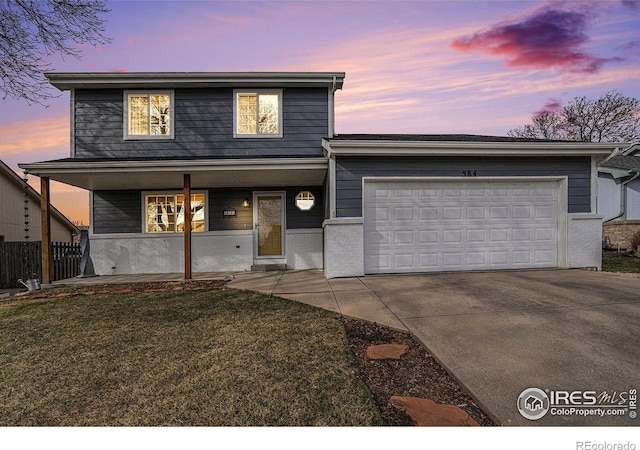 584 Sunwood Dr, Loveland, CO 80538 - view of front of home with concrete driveway, fence, a garage, a porch, and a yard