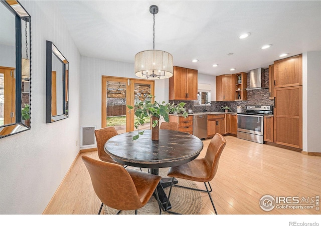 584 Sunwood Dr, Loveland, CO 80538 - dining space featuring baseboards, visible vents, a chandelier, and light wood-style floors