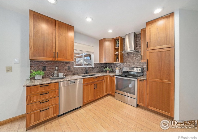 584 Sunwood Dr, Loveland, CO 80538 - kitchen featuring a sink, wall chimney exhaust hood, appliances with stainless steel finishes, light wood-style floors, and decorative backsplash