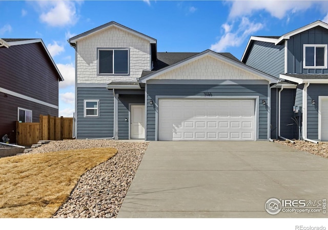 7153 Feather Reed Dr, Wellington, CO 80549 - view of front of property featuring driveway, fence, and an attached garage