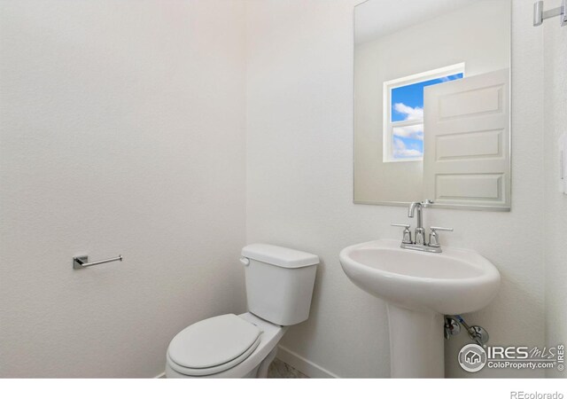 7153 Feather Reed Dr, Wellington, CO 80549 - bathroom with toilet and baseboards