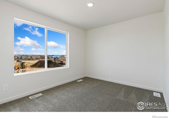 7153 Feather Reed Dr, Wellington, CO 80549 - empty room with baseboards, dark carpet, and visible vents