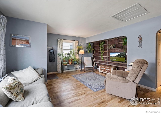117 Welch Ave, Berthoud, CO 80513 - living room featuring attic access, wood finished floors, and baseboards