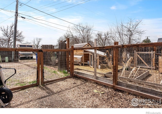 117 Welch Ave, Berthoud, CO 80513 - view of yard with a gate, a garden, and exterior structure