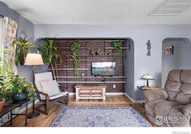 117 Welch Ave, Berthoud, CO 80513 - living area featuring wood finished floors, baseboards, and attic access