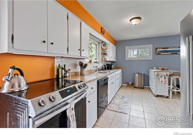 117 Welch Ave, Berthoud, CO 80513 - kitchen with electric range, black dishwasher, white cabinetry, a sink, and backsplash