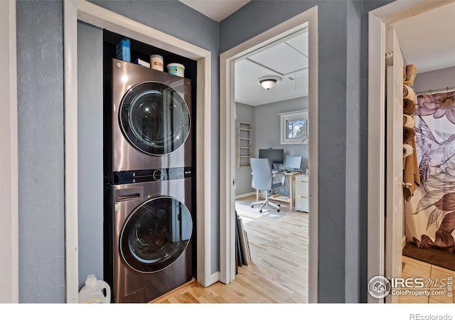 117 Welch Ave, Berthoud, CO 80513 - washroom with stacked washer and clothes dryer, wood finished floors, an office area, and baseboards