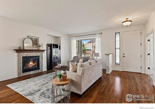 1827 Prairie Ridge Dr, Fort Collins, CO 80526 - living area with a tiled fireplace, dark wood-style floors, and baseboards