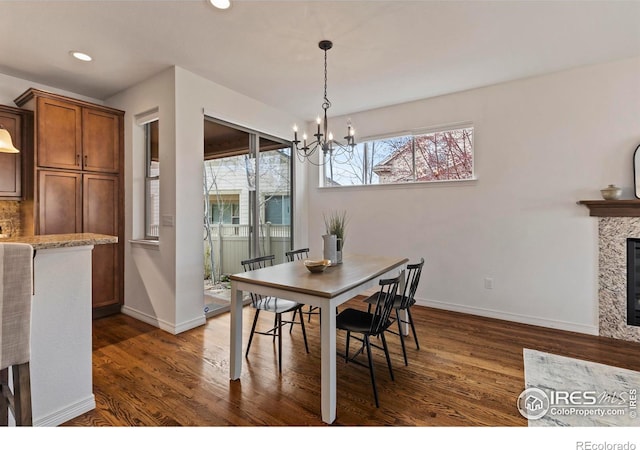 1827 Prairie Ridge Dr, Fort Collins, CO 80526 - dining area with baseboards, dark wood-style flooring, an inviting chandelier, and recessed lighting