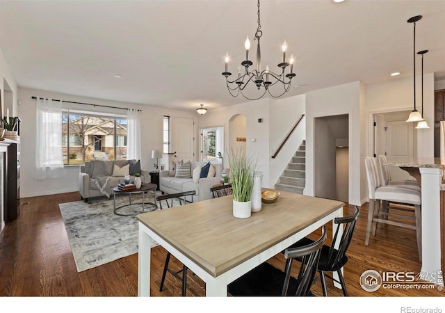 1827 Prairie Ridge Dr, Fort Collins, CO 80526 - dining space with stairs, arched walkways, dark wood-type flooring, and a chandelier