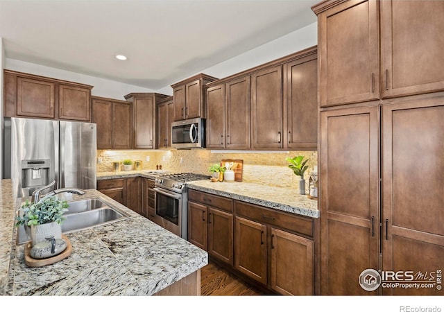 1827 Prairie Ridge Dr, Fort Collins, CO 80526 - kitchen with recessed lighting, appliances with stainless steel finishes, dark wood-type flooring, a sink, and backsplash