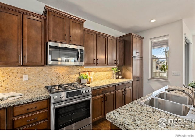 1827 Prairie Ridge Dr, Fort Collins, CO 80526 - kitchen featuring light countertops, a sink, stainless steel appliances, and tasteful backsplash