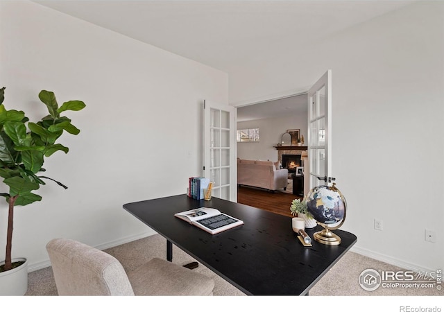 1827 Prairie Ridge Dr, Fort Collins, CO 80526 - office with baseboards, french doors, and a warm lit fireplace