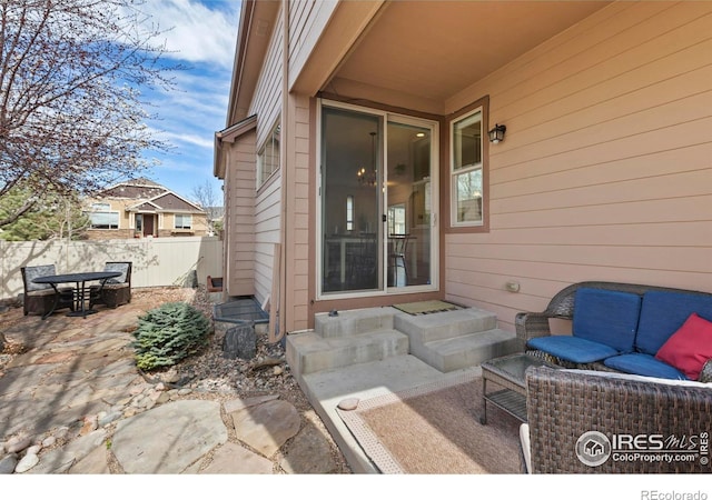 1827 Prairie Ridge Dr, Fort Collins, CO 80526 - view of patio featuring outdoor dining space, entry steps, and fence