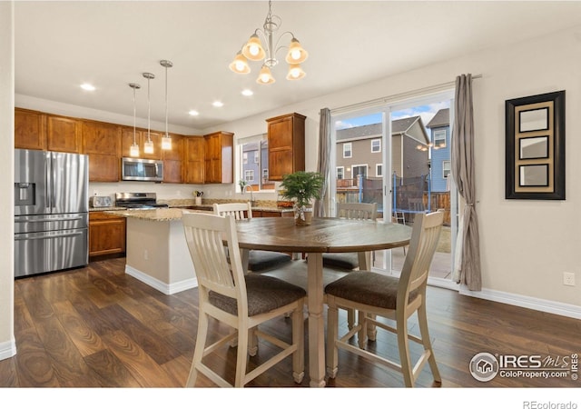 dining room featuring a notable chandelier, dark wood-style floors, baseboards, and recessed lighting