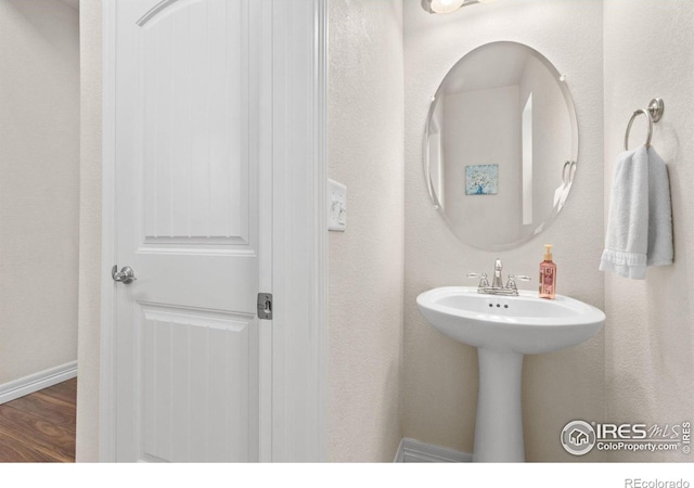 bathroom featuring baseboards and wood finished floors