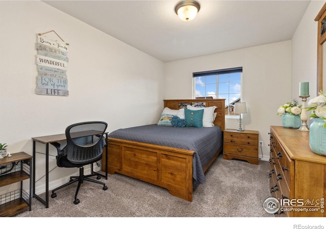 carpeted bedroom featuring baseboards