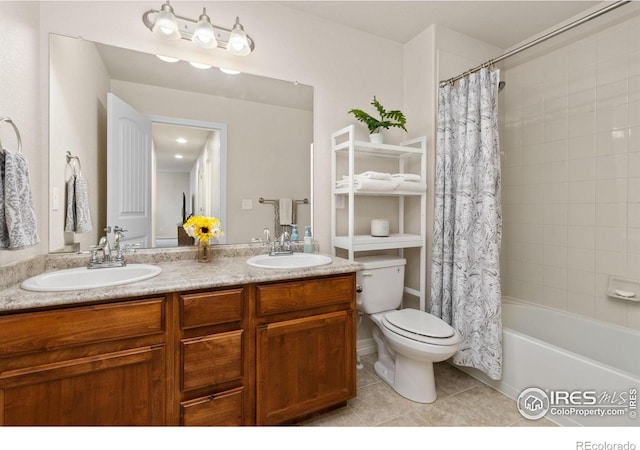 bathroom featuring tile patterned floors, a sink, toilet, and double vanity