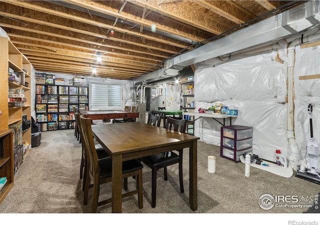 dining space with heating unit, water heater, and carpet floors