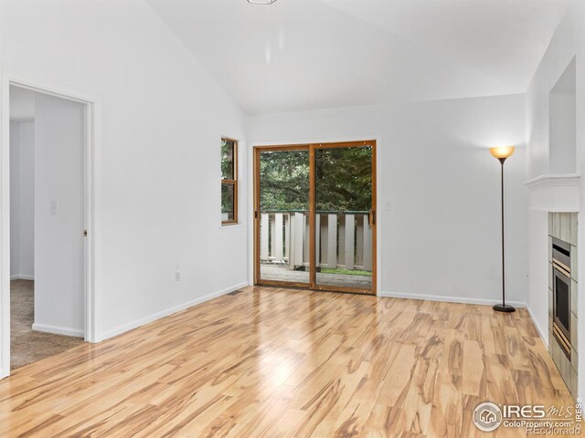 1010 S Saint Vrain Ave S, Estes Park, CO 80517 - unfurnished living room with wood finished floors, a fireplace, baseboards, and lofted ceiling
