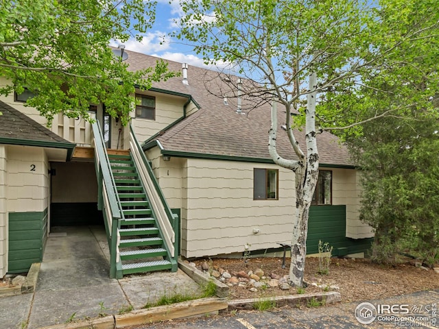 1010 S Saint Vrain Ave S, Estes Park, CO 80517 - back of property with roof with shingles and stairs