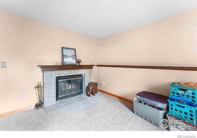1640 Kirkwood Dr Unit 2011, Fort Collins, CO 80526 - carpeted living area featuring baseboards, a fireplace, and a textured ceiling