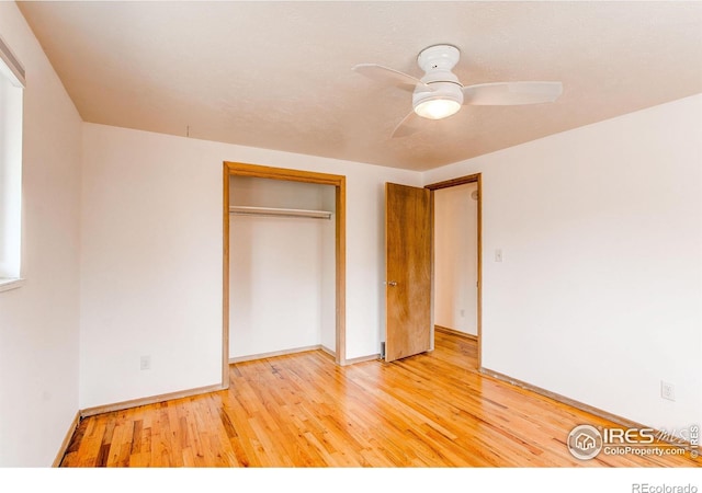 unfurnished bedroom with baseboards, light wood-type flooring, a closet, and ceiling fan