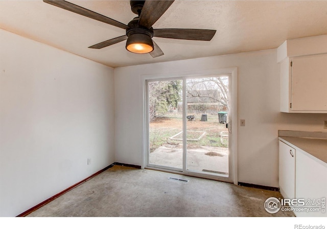 interior space featuring baseboards, visible vents, and a ceiling fan