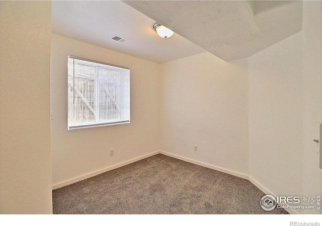 unfurnished room featuring visible vents, baseboards, and carpet floors