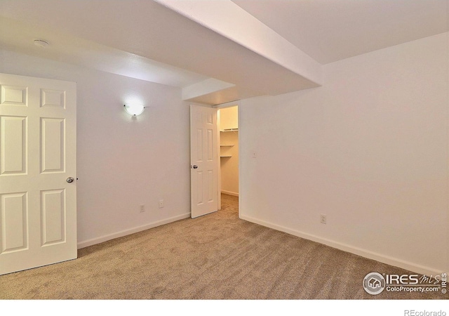 interior space featuring baseboards and carpet
