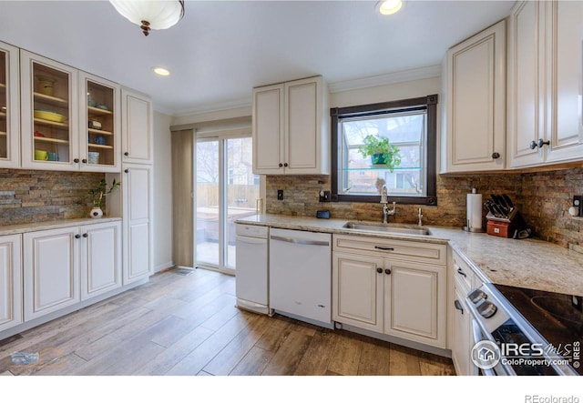 kitchen featuring a sink, crown molding, dishwasher, and stainless steel electric range oven