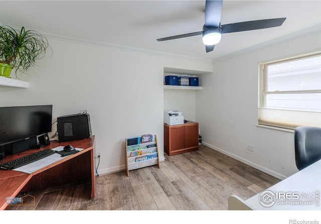 office area featuring baseboards, ornamental molding, wood finished floors, and a ceiling fan