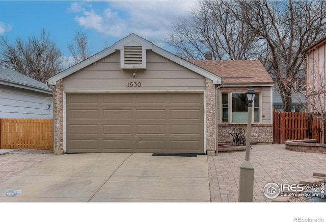 view of front facade with fence, a garage, concrete driveway, brick siding, and a shingled roof