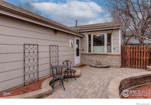view of patio / terrace featuring fence