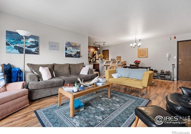 1315 Kirkwood Dr Unit 804, Fort Collins, CO 80525 - living room with a notable chandelier, wood finished floors, and rail lighting