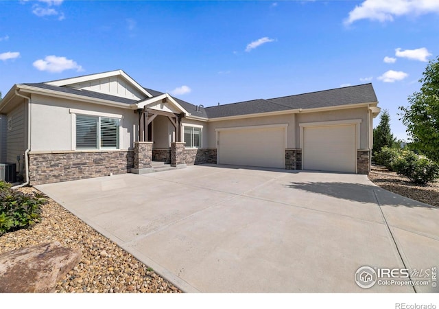 5977 Crooked Stick Dr, Windsor, CO 80550 - craftsman-style home with stone siding, a garage, driveway, and stucco siding
