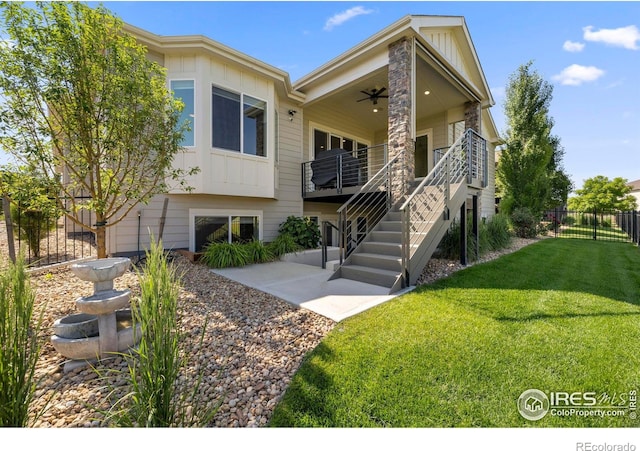 5977 Crooked Stick Dr, Windsor, CO 80550 - view of front of house with board and batten siding, a ceiling fan, and stairs