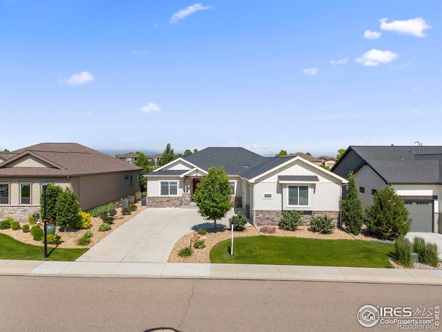 5977 Crooked Stick Dr, Windsor, CO 80550 - craftsman-style home with stone siding, driveway, a front yard, and a residential view