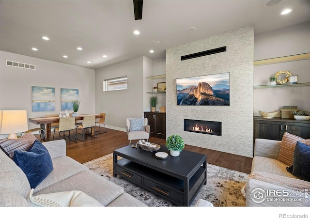 5977 Crooked Stick Dr, Windsor, CO 80550 - living room with wood finished floors, recessed lighting, and a stone fireplace