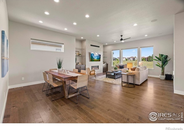 5977 Crooked Stick Dr, Windsor, CO 80550 - dining space featuring recessed lighting, wood finished floors, a large fireplace, and a ceiling fan