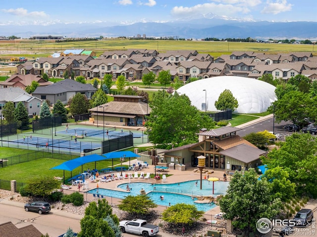 5977 Crooked Stick Dr, Windsor, CO 80550 - aerial view of residential area with a pool and a mountain backdrop