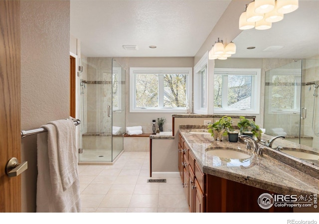 1117 Barberry Ct, Boulder, CO 80305 - bathroom with tile patterned flooring, a stall shower, vanity, a textured wall, and a textured ceiling
