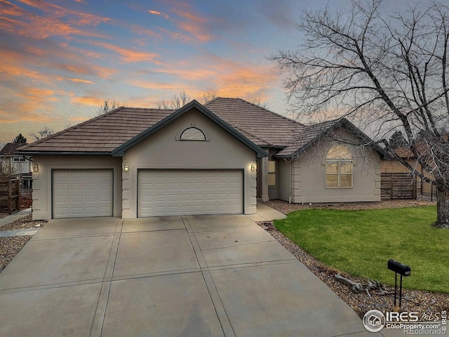 1730 Crestone Dr, Longmont, CO 80504 - ranch-style home featuring stucco siding, a garage, driveway, and a tiled roof