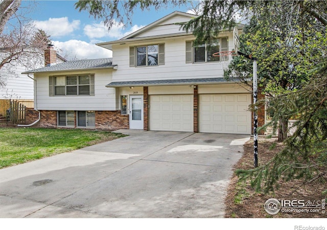 tri-level home with driveway, a front lawn, brick siding, a garage, and a shingled roof
