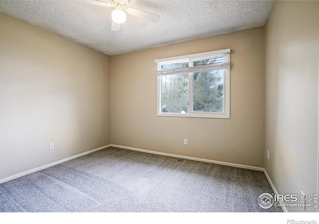 unfurnished room with a textured ceiling, baseboards, carpet flooring, and a ceiling fan
