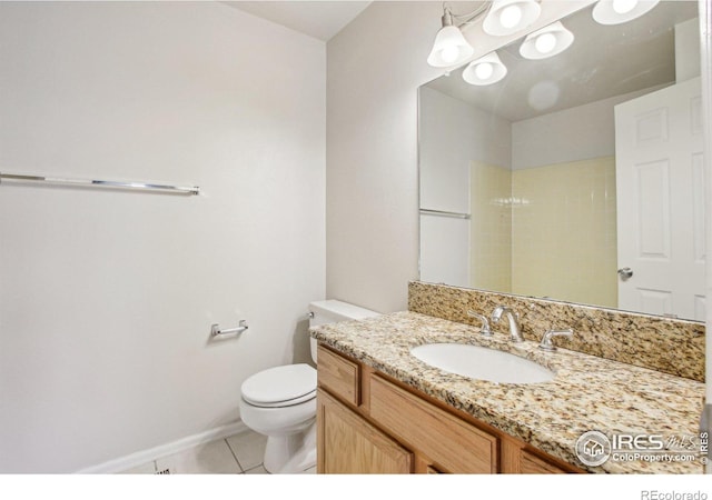 bathroom with baseboards, toilet, tile patterned flooring, and vanity