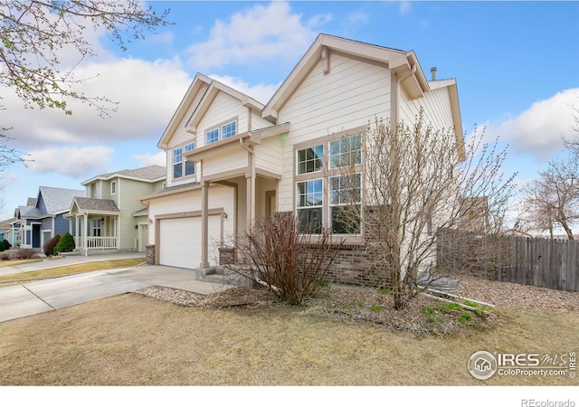 view of front of property featuring driveway, a garage, and fence