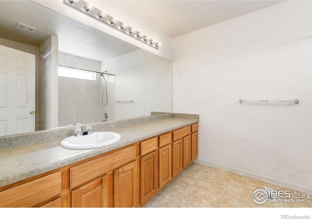 full bath featuring baseboards, visible vents, and vanity